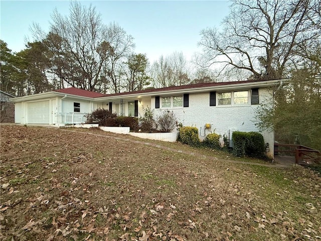 view of front of house with a front lawn, covered porch, and a garage