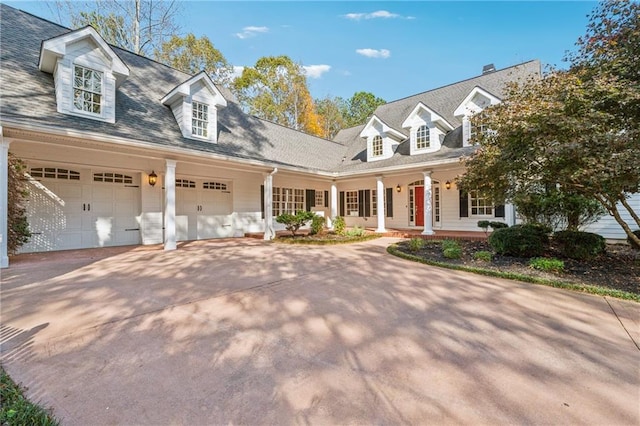 cape cod-style house with a porch and a garage