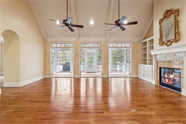 220 Spring Branch Dr, Canton, GA 30115 - unfurnished living room featuring wood finished floors, a ceiling fan, baseboards, plenty of natural light, and beamed ceiling