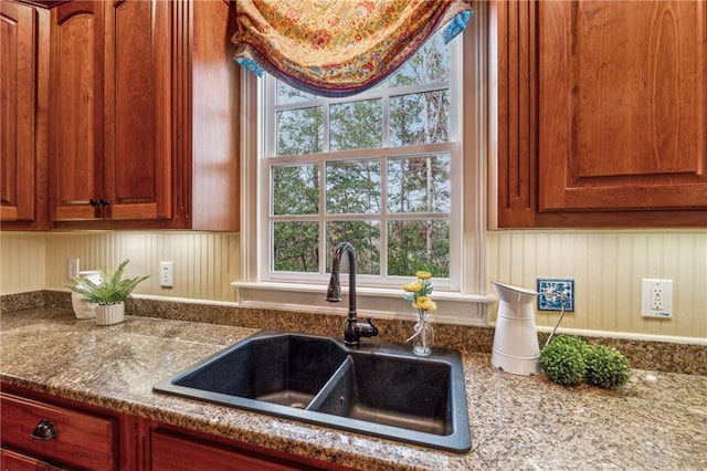 220 Spring Branch Dr, Canton, GA 30115 - kitchen with a sink, stone countertops, wooden walls, and brown cabinetry