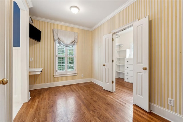 unfurnished bedroom featuring hardwood / wood-style flooring and ornamental molding