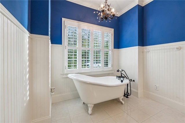 bathroom featuring tile patterned floors, a chandelier, a bath, and ornamental molding