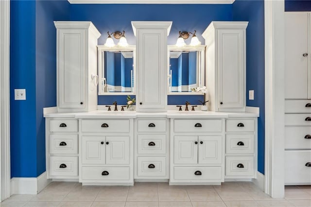 bathroom featuring tile patterned floors, crown molding, and vanity