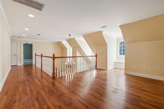 bonus room with dark hardwood / wood-style flooring and a chandelier