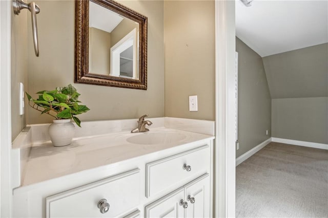 bathroom featuring vanity and lofted ceiling