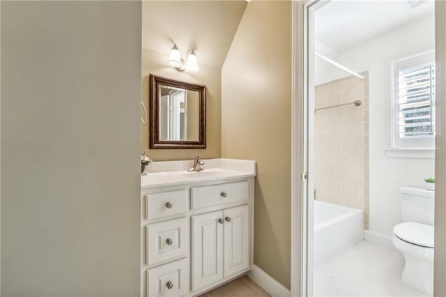 full bathroom featuring tile patterned floors, vanity, vaulted ceiling, toilet, and tiled shower / bath