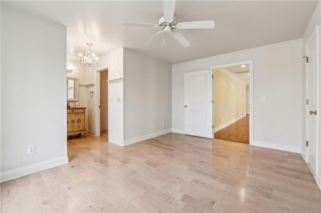 unfurnished bedroom with ceiling fan with notable chandelier, light hardwood / wood-style floors, and ensuite bathroom