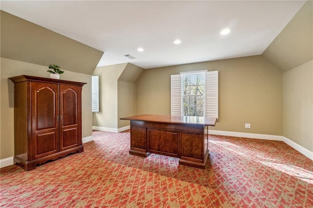 unfurnished office featuring light colored carpet and vaulted ceiling