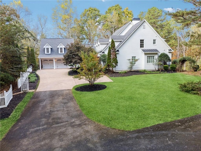 view of front of house featuring a garage and a front lawn