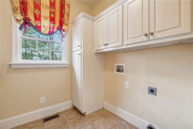 washroom featuring electric dryer hookup, light tile patterned flooring, cabinets, and hookup for a washing machine