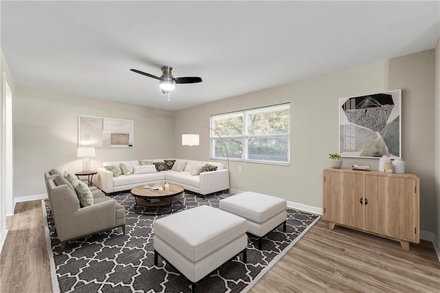 living room featuring hardwood / wood-style floors and ceiling fan