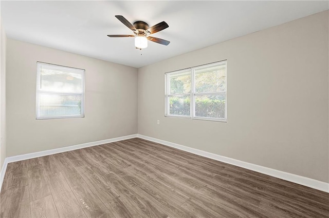 spare room with hardwood / wood-style flooring and ceiling fan