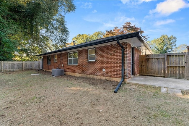 view of side of property with central air condition unit and a patio area