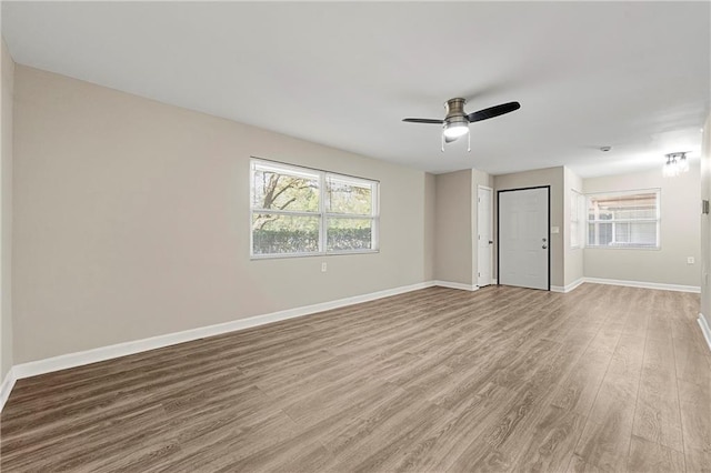 empty room with light hardwood / wood-style floors and ceiling fan