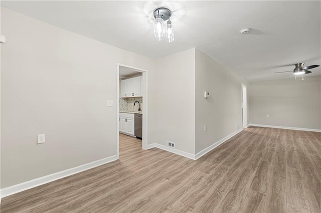 unfurnished room with ceiling fan and light hardwood / wood-style flooring