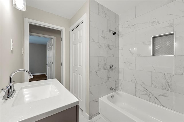 bathroom featuring vanity and tiled shower / bath combo