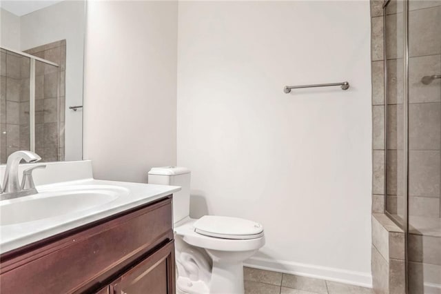 bathroom with vanity, tile patterned floors, toilet, and walk in shower