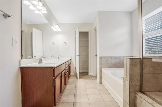 bathroom featuring vanity, a bathing tub, and tile patterned flooring