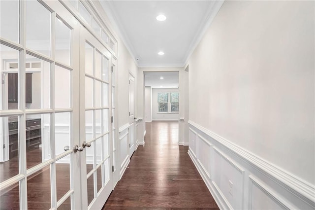 hall with ornamental molding, dark hardwood / wood-style flooring, and french doors