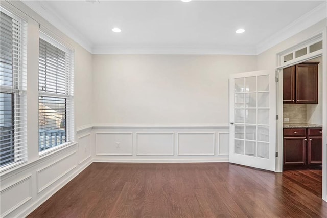 unfurnished dining area featuring dark wood-type flooring and ornamental molding