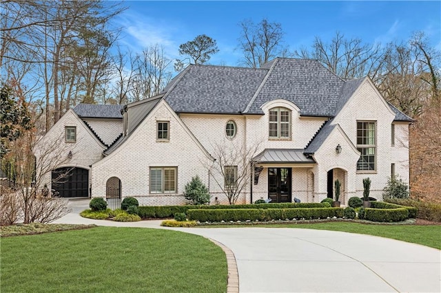 french country inspired facade with a front yard