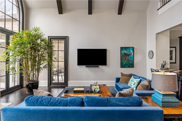 living room with hardwood / wood-style floors, beam ceiling, and french doors