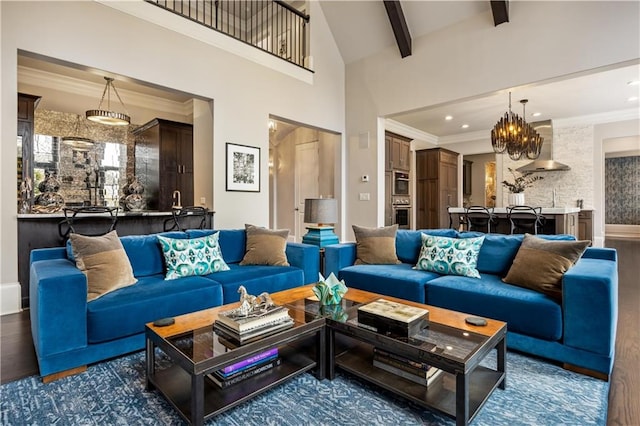 living room featuring dark hardwood / wood-style floors, ornamental molding, and beam ceiling