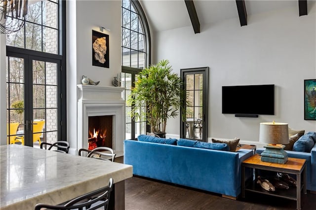 living room featuring dark wood-type flooring, beam ceiling, high vaulted ceiling, and french doors