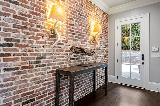 doorway featuring crown molding, brick wall, and dark hardwood / wood-style flooring