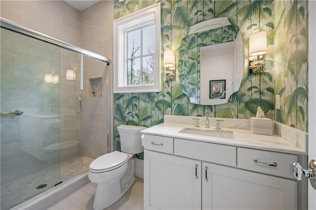 bathroom with tile patterned flooring, walk in shower, vanity, and toilet