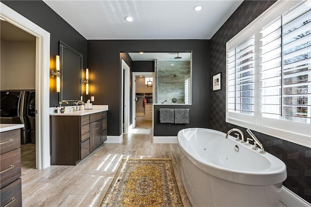 bathroom featuring vanity, plus walk in shower, and wood-type flooring