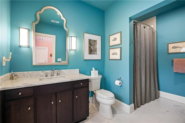 bathroom with vanity, curtained shower, and toilet