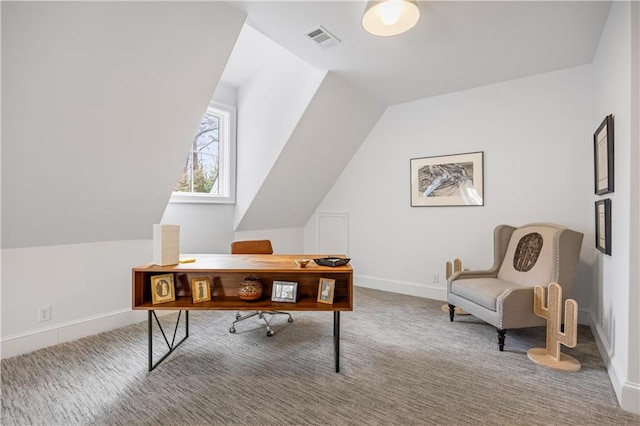 carpeted office with vaulted ceiling