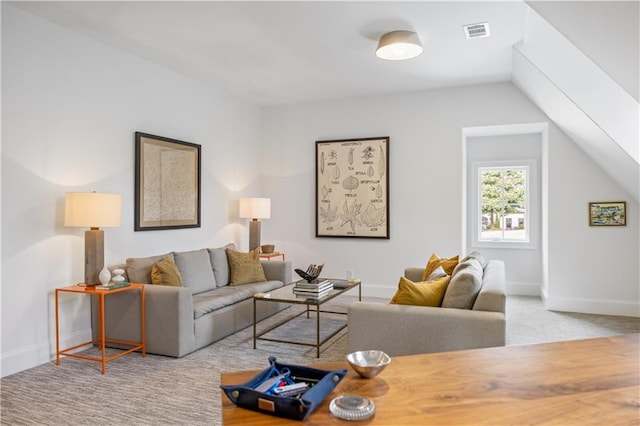 carpeted living room with vaulted ceiling