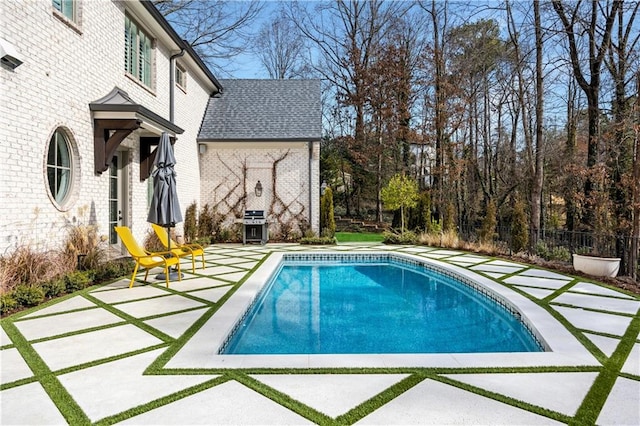 view of swimming pool with area for grilling and a patio