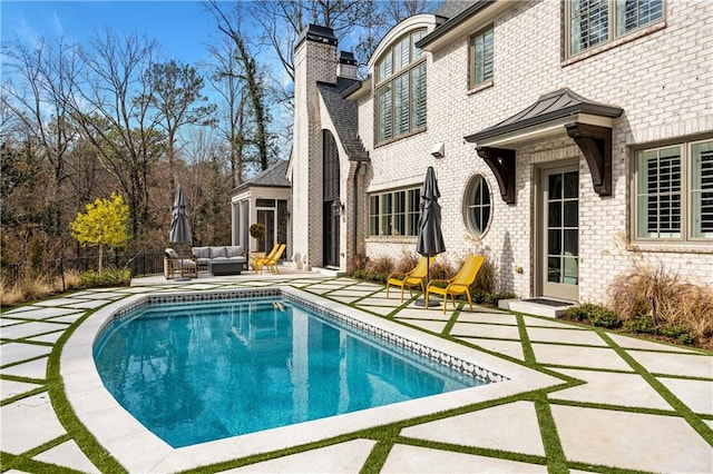 view of swimming pool with outdoor lounge area and a patio area