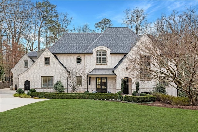 french country style house with a front yard