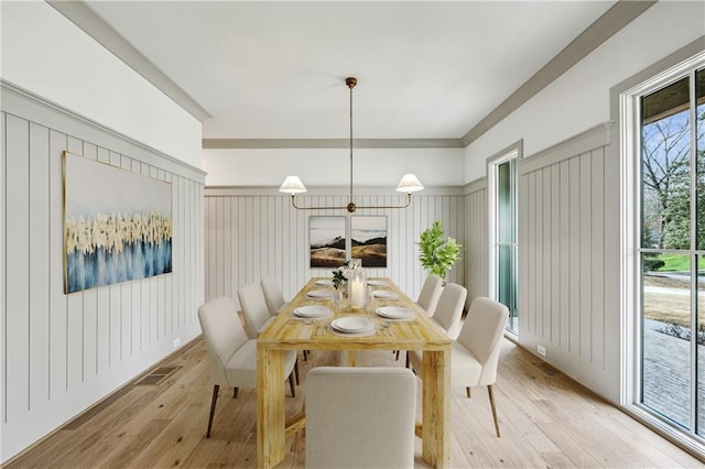 dining room featuring light wood finished floors and visible vents