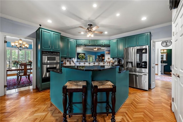 1703 Brandywine Ct, Atlanta, GA 30338 - kitchen featuring appliances with stainless steel finishes, a ceiling fan, a chandelier, dark countertops, and a breakfast bar area