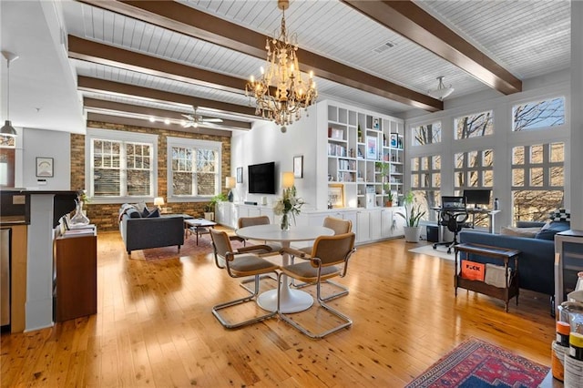 dining room with beamed ceiling, brick wall, light hardwood / wood-style flooring, and plenty of natural light