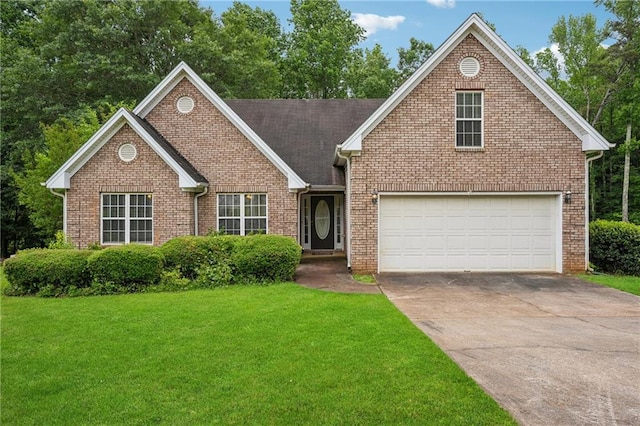 605 Pebble Blvd, Covington, GA 30016 - view of front of house with driveway, a front yard, brick siding, and an attached garage