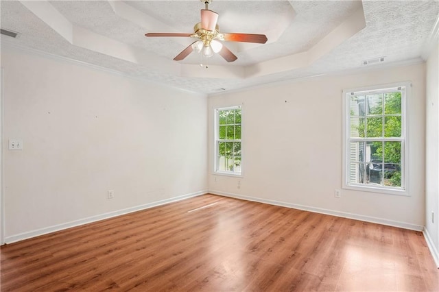 605 Pebble Blvd, Covington, GA 30016 - spare room with a textured ceiling, a raised ceiling, light wood finished floors, baseboards, and ornamental molding