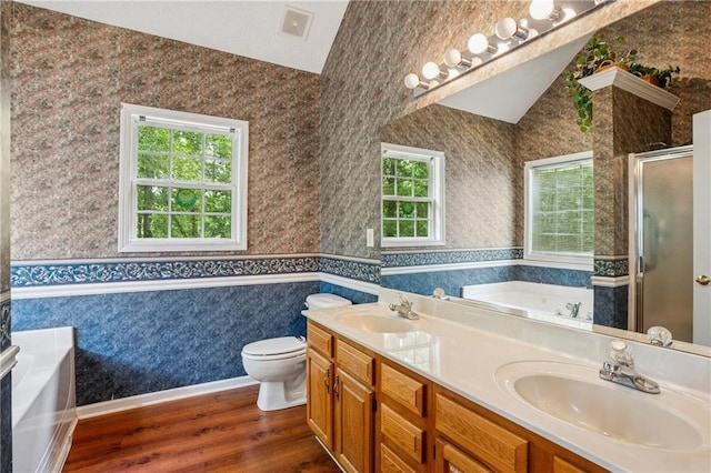 605 Pebble Blvd, Covington, GA 30016 - bathroom with lofted ceiling, a shower stall, a bath, wallpapered walls, and wood finished floors