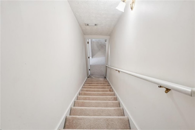 605 Pebble Blvd, Covington, GA 30016 - stairway featuring a textured ceiling, baseboards, and carpet floors