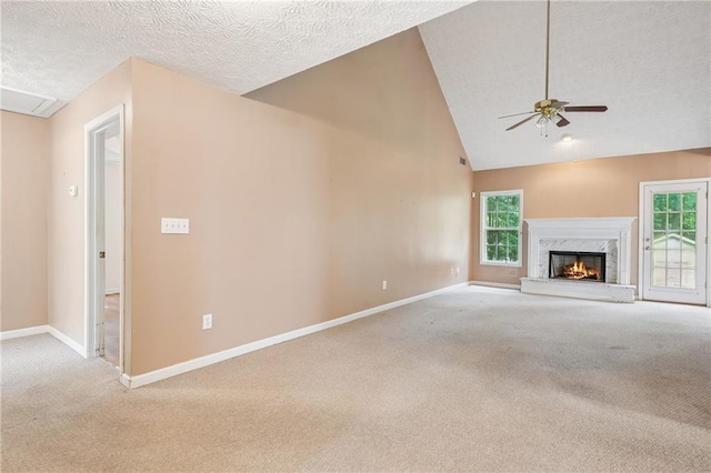 605 Pebble Blvd, Covington, GA 30016 - unfurnished living room featuring carpet flooring, baseboards, a ceiling fan, a fireplace, and a textured ceiling