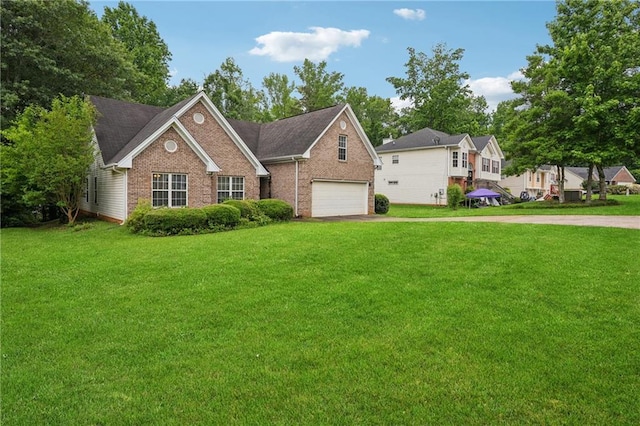 605 Pebble Blvd, Covington, GA 30016 - view of front of home with brick siding, a front lawn, driveway, and a garage