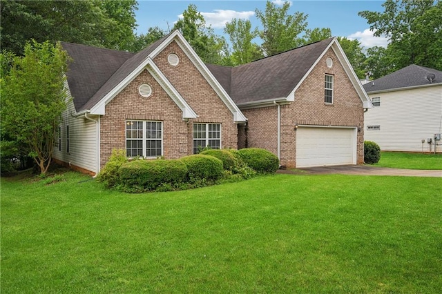 605 Pebble Blvd, Covington, GA 30016 - view of front of house featuring driveway, brick siding, an attached garage, and a front lawn