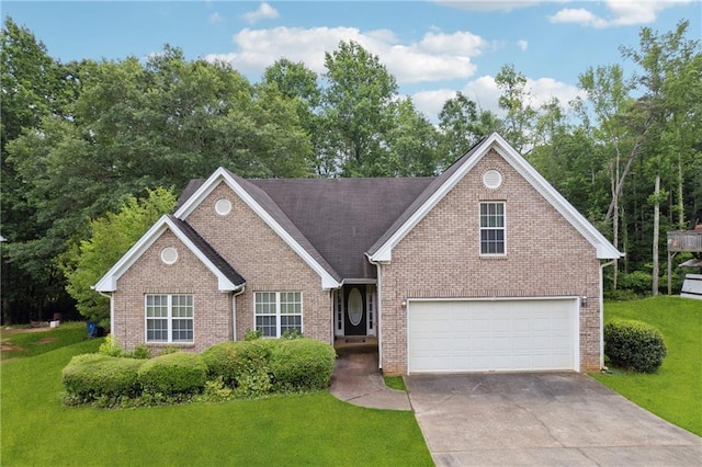 605 Pebble Blvd, Covington, GA 30016 - view of front of home with driveway, a front yard, and brick siding