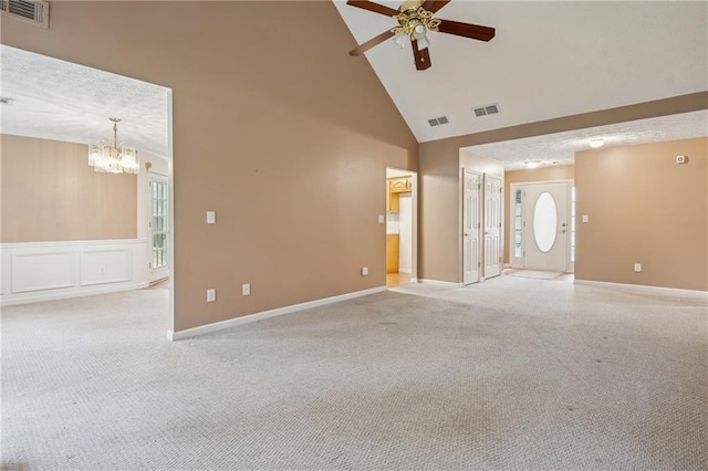 605 Pebble Blvd, Covington, GA 30016 - spare room featuring a chandelier, ceiling fan, high vaulted ceiling, light colored carpet, and baseboards