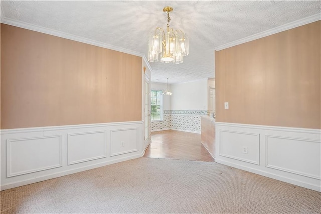 605 Pebble Blvd, Covington, GA 30016 - carpeted empty room featuring a chandelier, crown molding, a wainscoted wall, and a textured ceiling